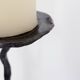 Large wrought iron candelabrum with an abstract design and three candle holders.