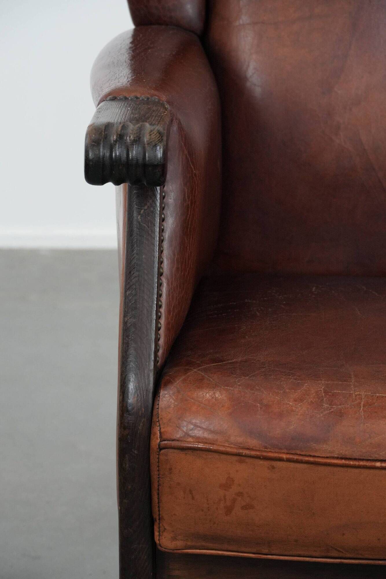 Classic vintage wingback chair in sheepskin and wood
