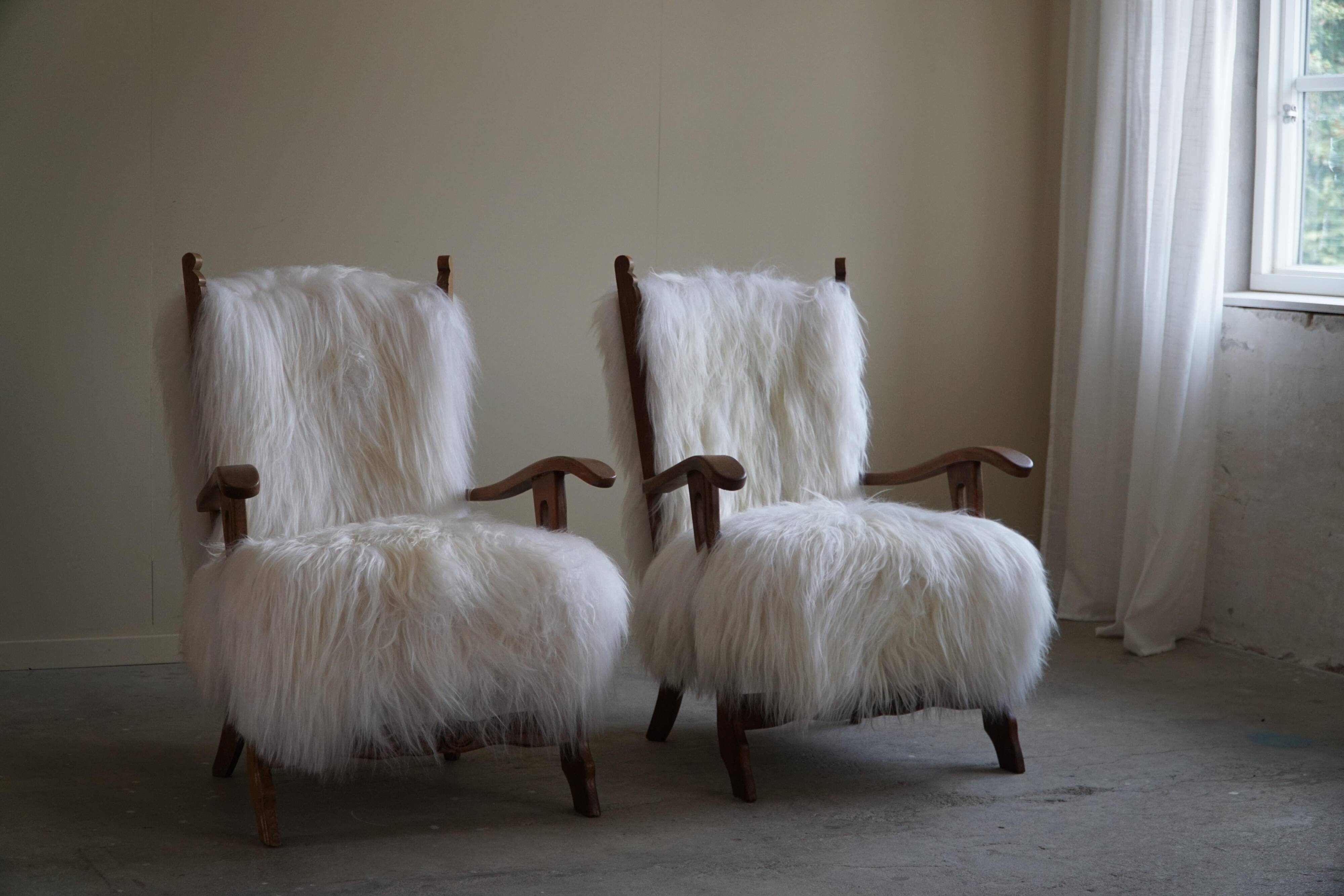 Pair of Scandinavian armchairs in oak and long-haired Icelandic sheepskin by Henning Kjærnulf, 1950.