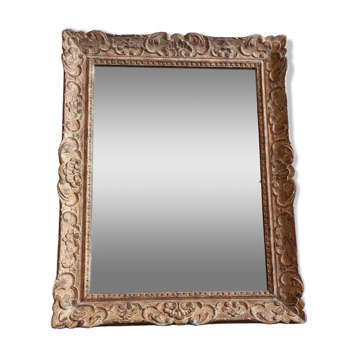 Large Montparnasse rocaille style frame in carved wood mounted in mirror.