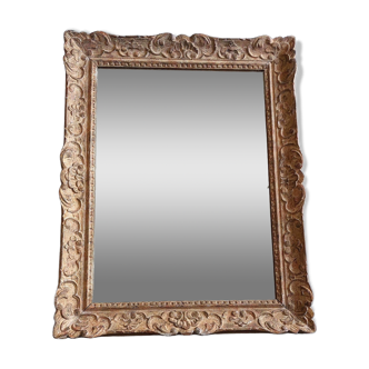 Large Montparnasse rocaille style frame in carved wood mounted in mirror.