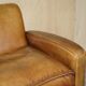 Three-seater Art Deco style leather sofa with feather cushions.