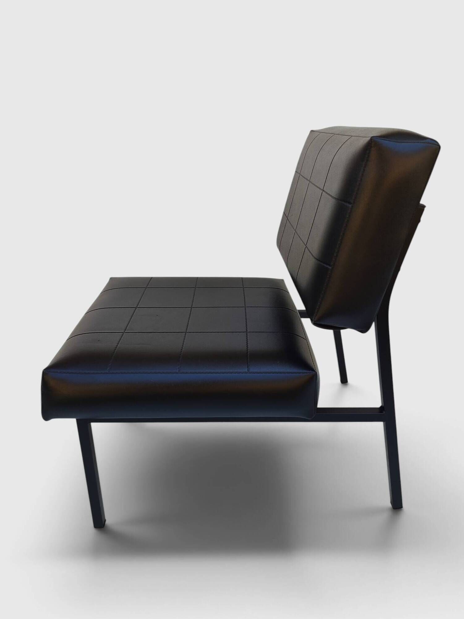 Modernist armchair in black faux leather and metal – 1960s