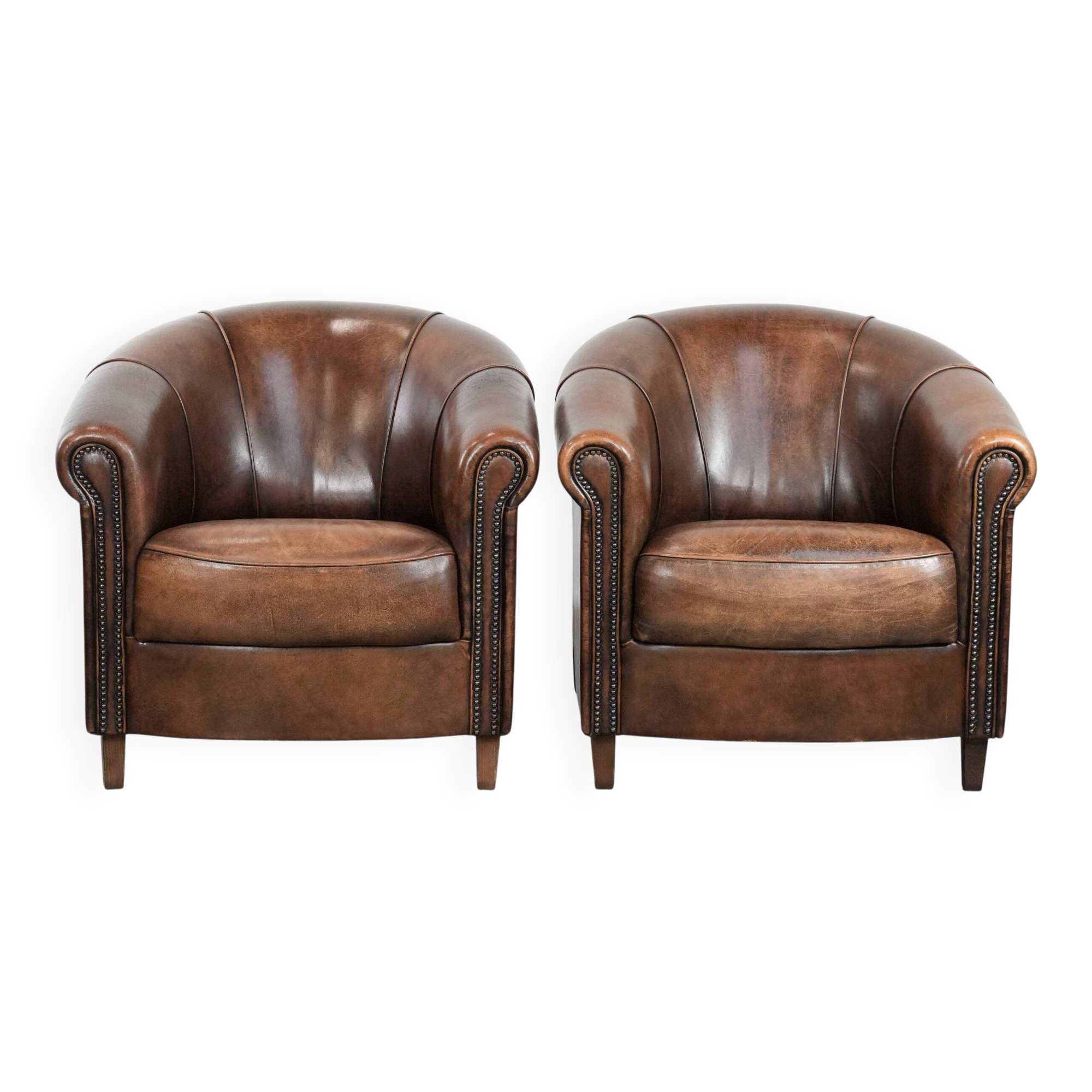 Set of two sheepskin club armchairs with fixed seat cushions