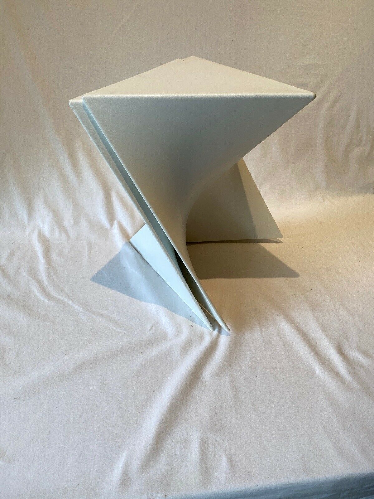 Pair of unmarked triangular white design stools