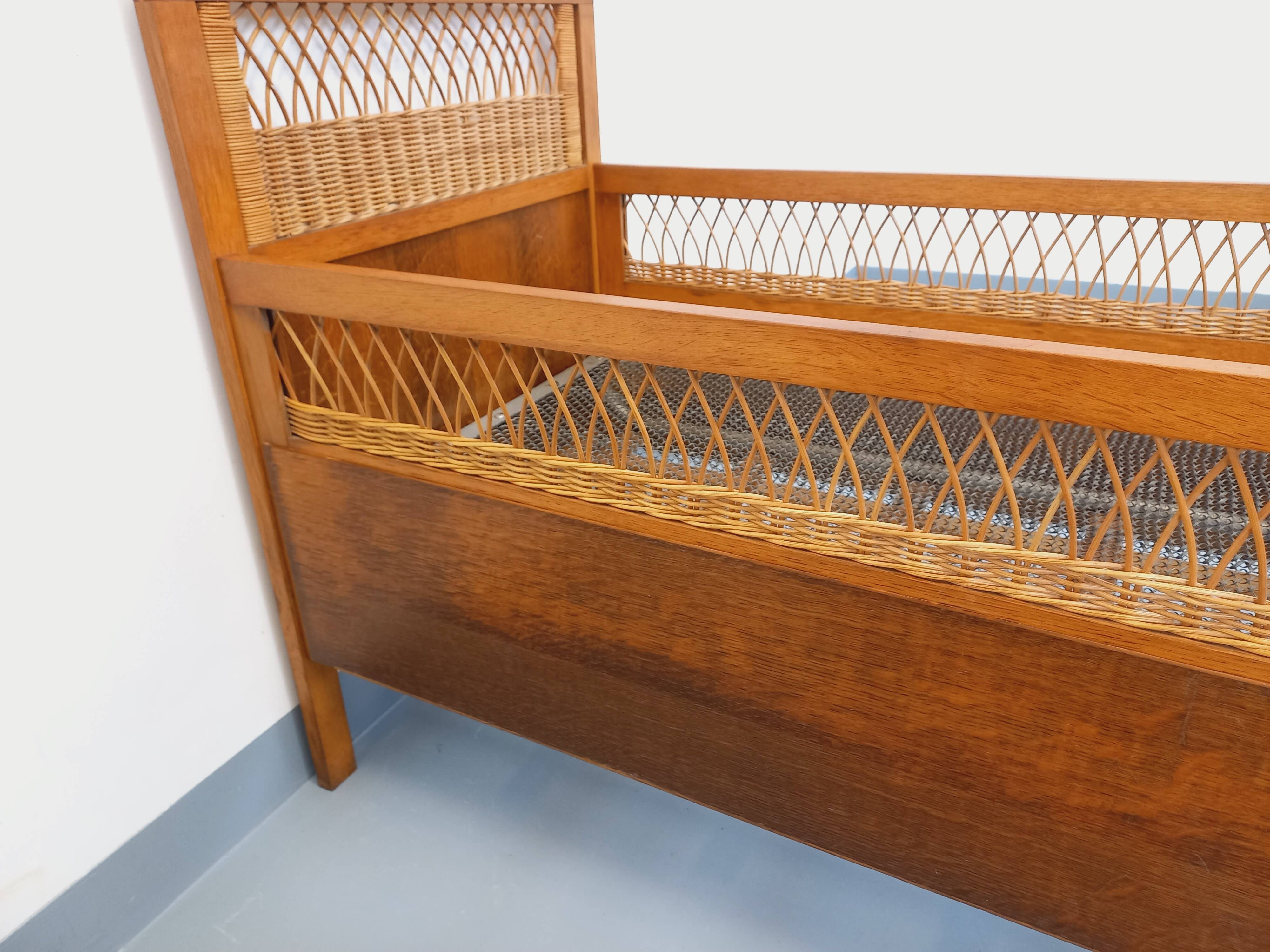 Vintage oak and rattan baby cot from the 1960s.