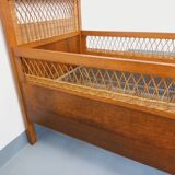 Vintage oak and rattan baby cot from the 1960s.