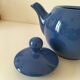 Vintage deep blue teapot, minimalist round shape.