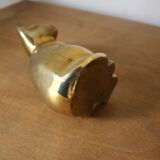 Cat sitting in brass