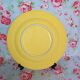 Old round plate in yellow faïence
