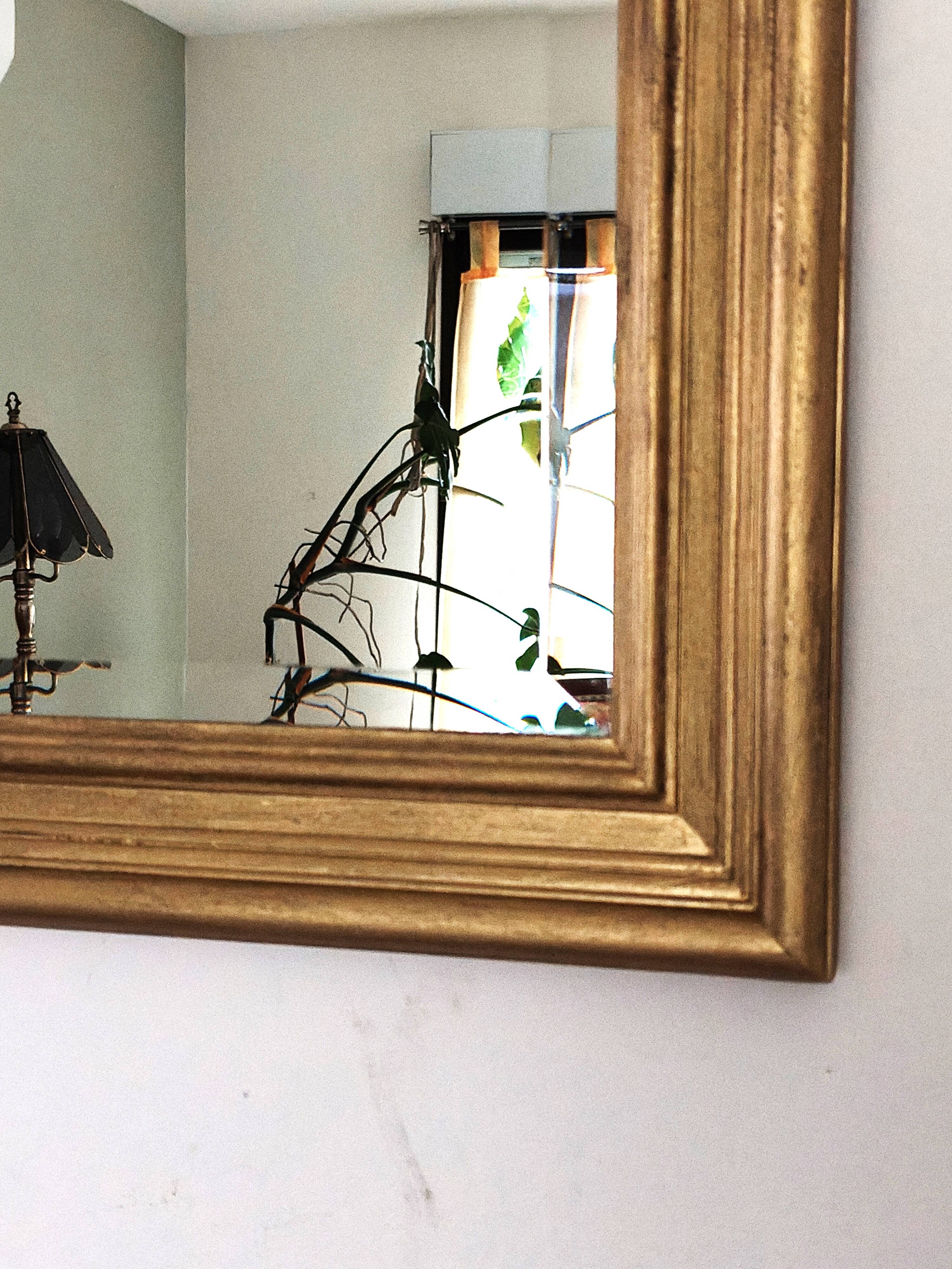 Large gold-framed mirror with bevelled glass.