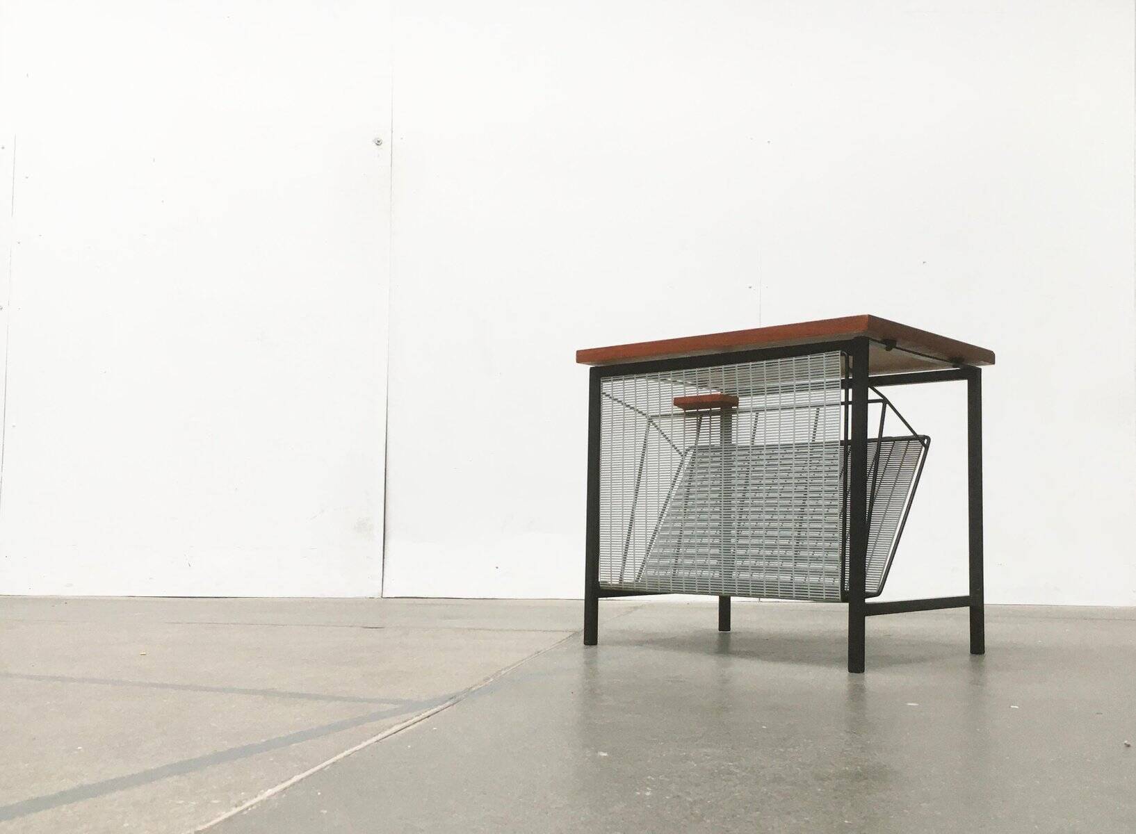 Mid-century teak side table with magazine rack.
