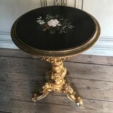 A gilded carved wooden pedestal table with a marble marquetry top