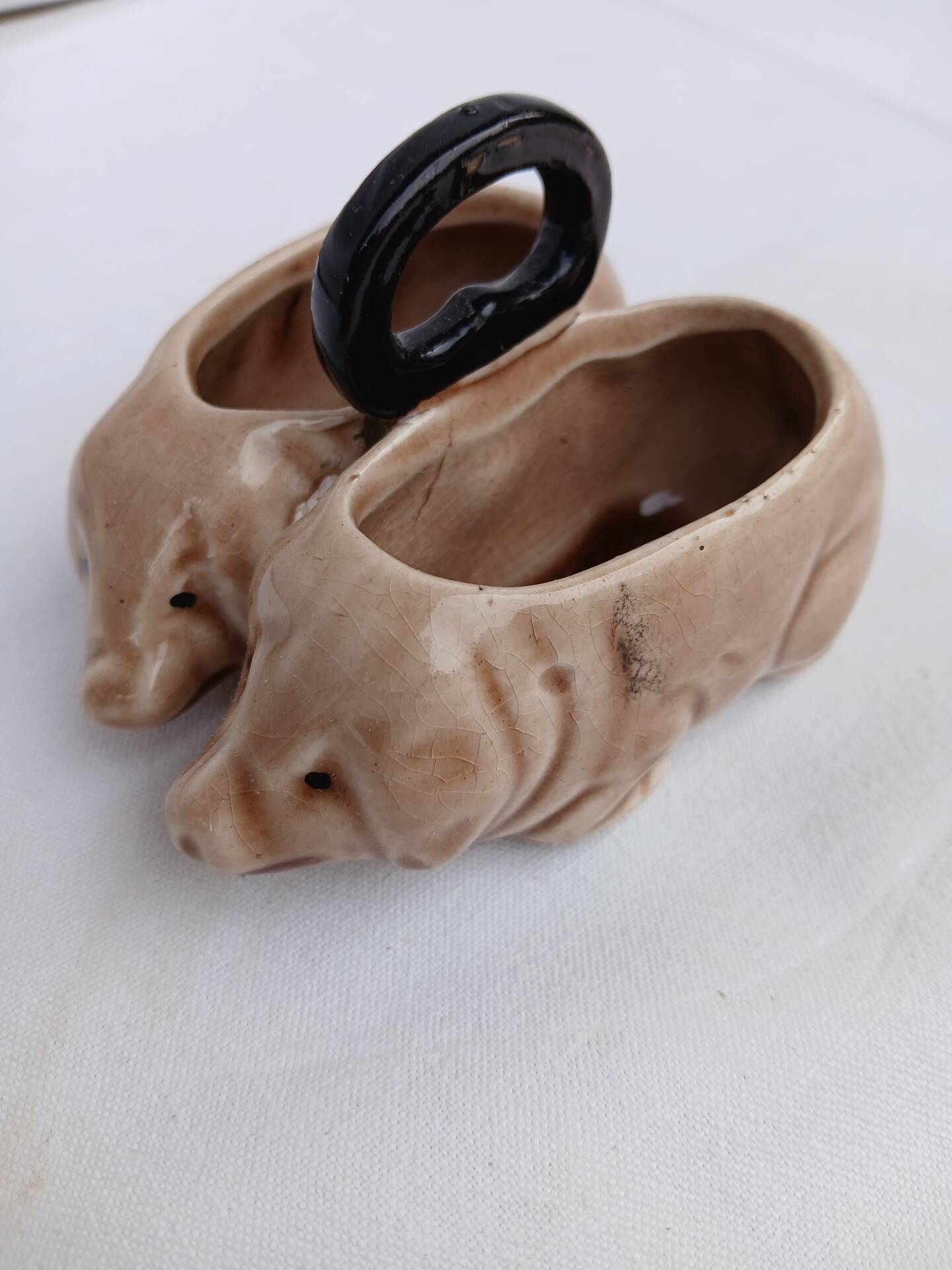 Old ceramic salt and pepper shaker in the shape of pigs.