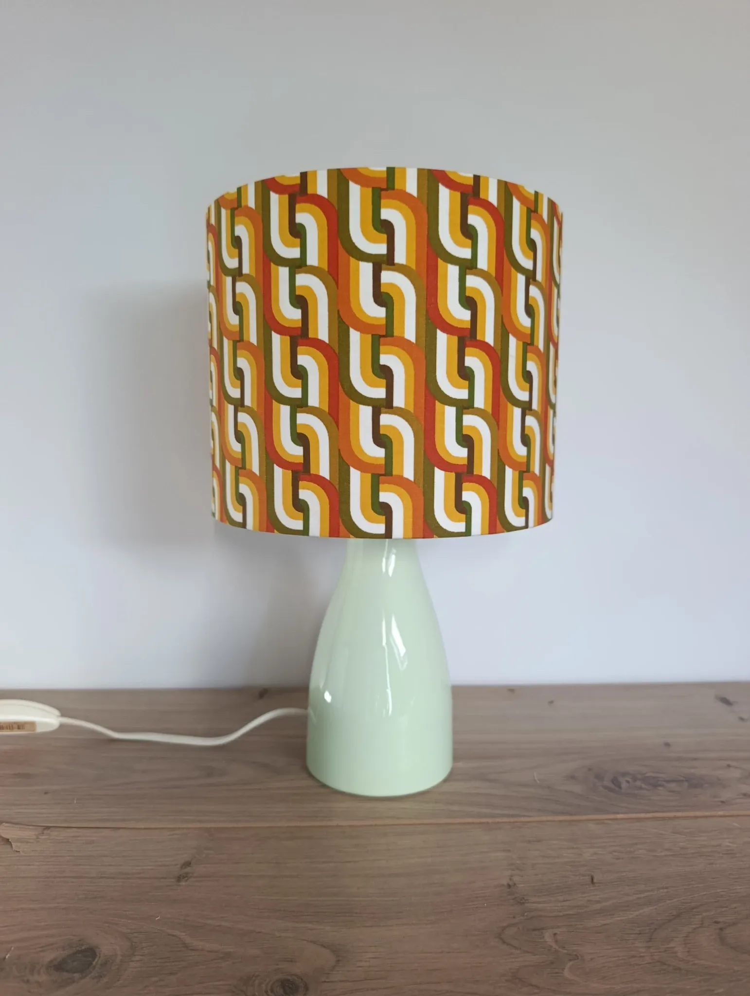 Seventies spirit lamp with geometric orange/green lampshade.