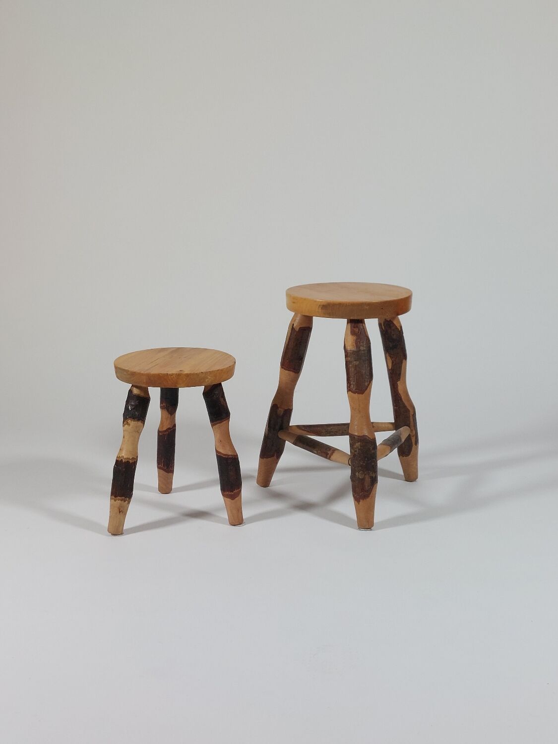 Pair of walnut stools sculpted in a vintage mid-century cross-section.