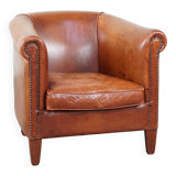 Cognac-colored cow leather club chair finished with decorative nails in English style