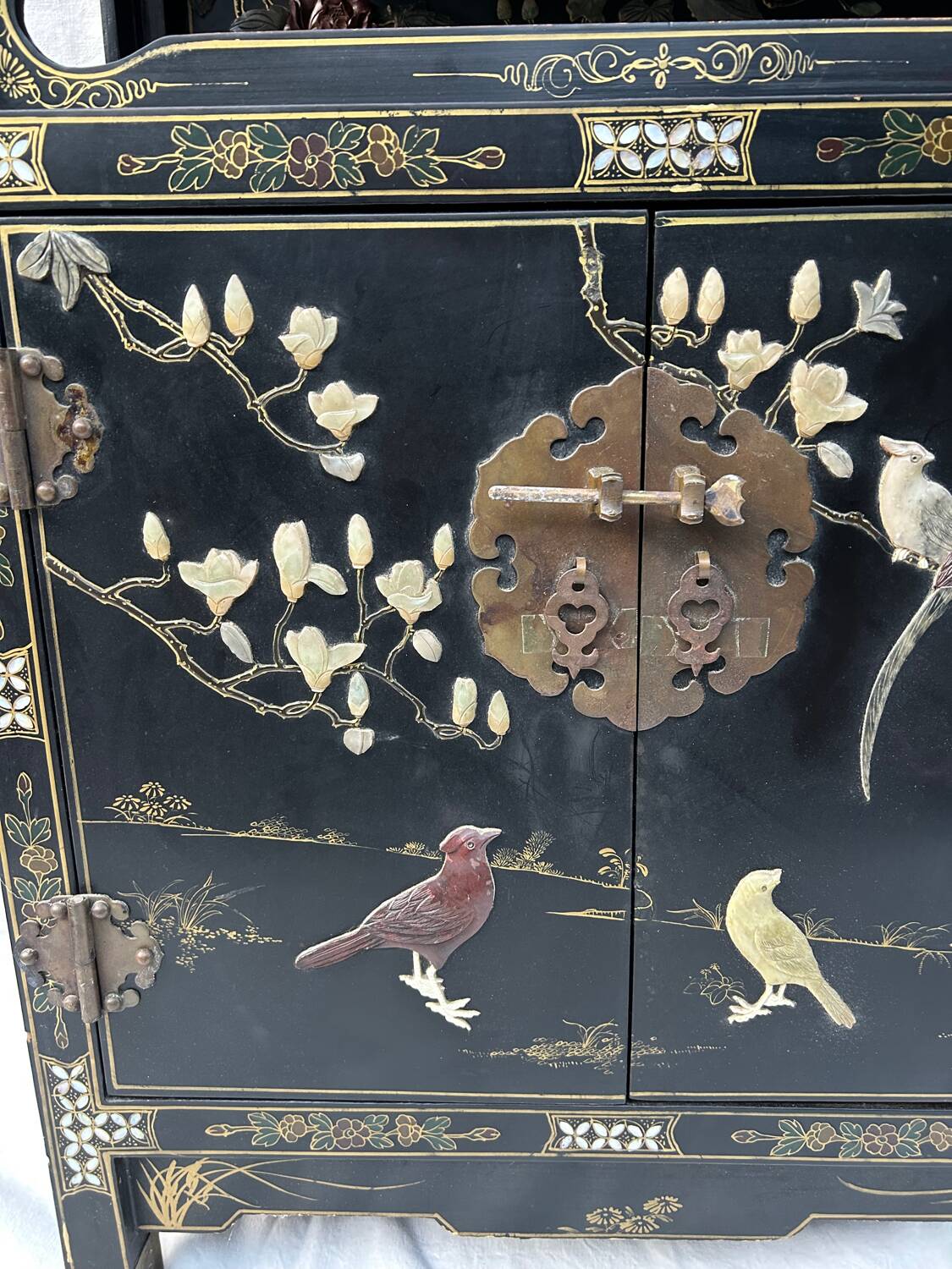 Chinese sideboard with gold lacquer and mother-of-pearl inlay. Bird and landscape decor.