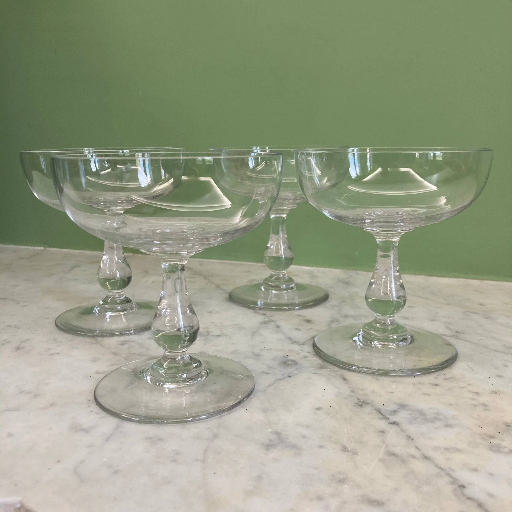 4 Baccarat crystal champagne coupes in a gondola shape.