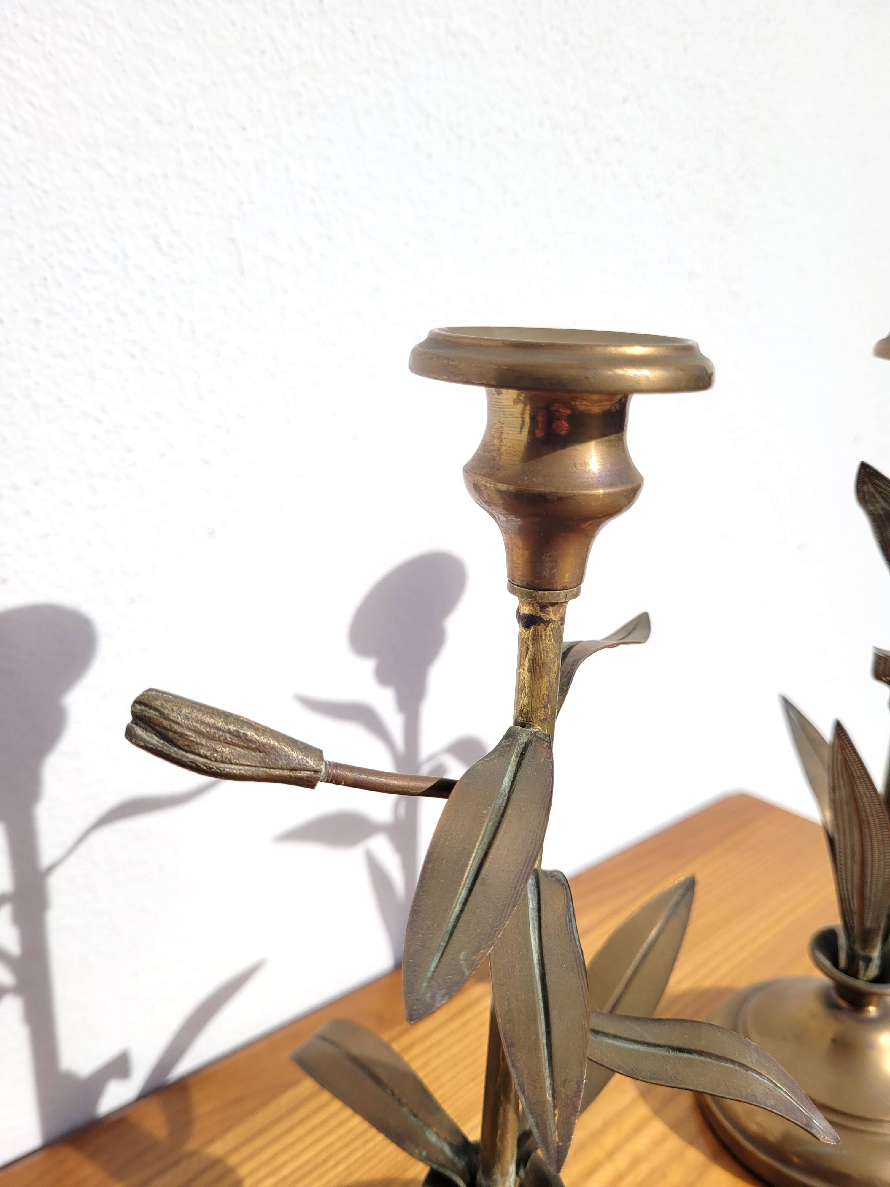 Pair of brass candlesticks with plant decoration