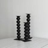 three designer candle holders in matte black metal