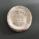 Character on plaster medallion