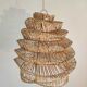Braided rattan suspension in the shape of a natural accordion