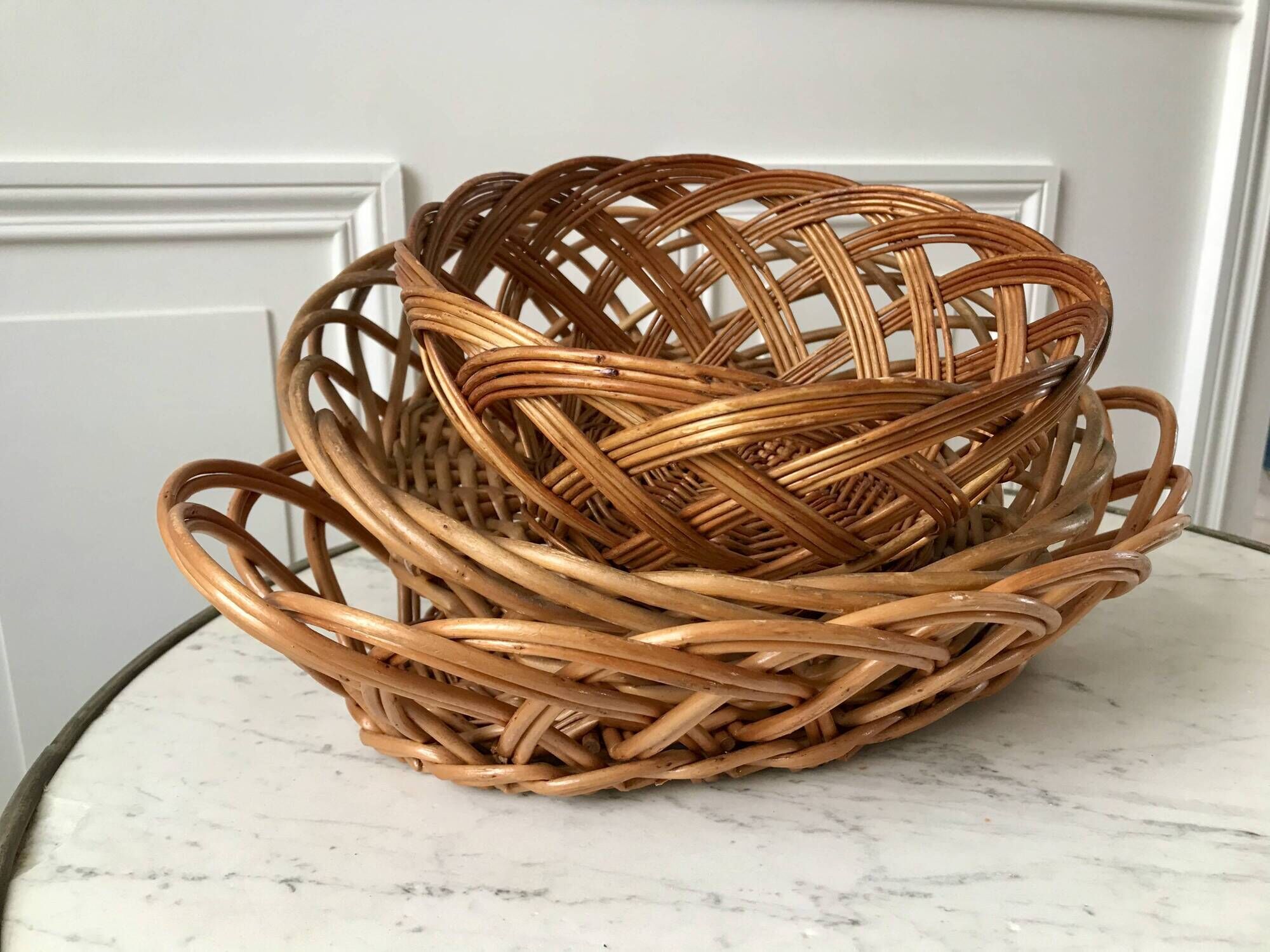 trio of woven rattan and bamboo baskets from the 60s and 70s