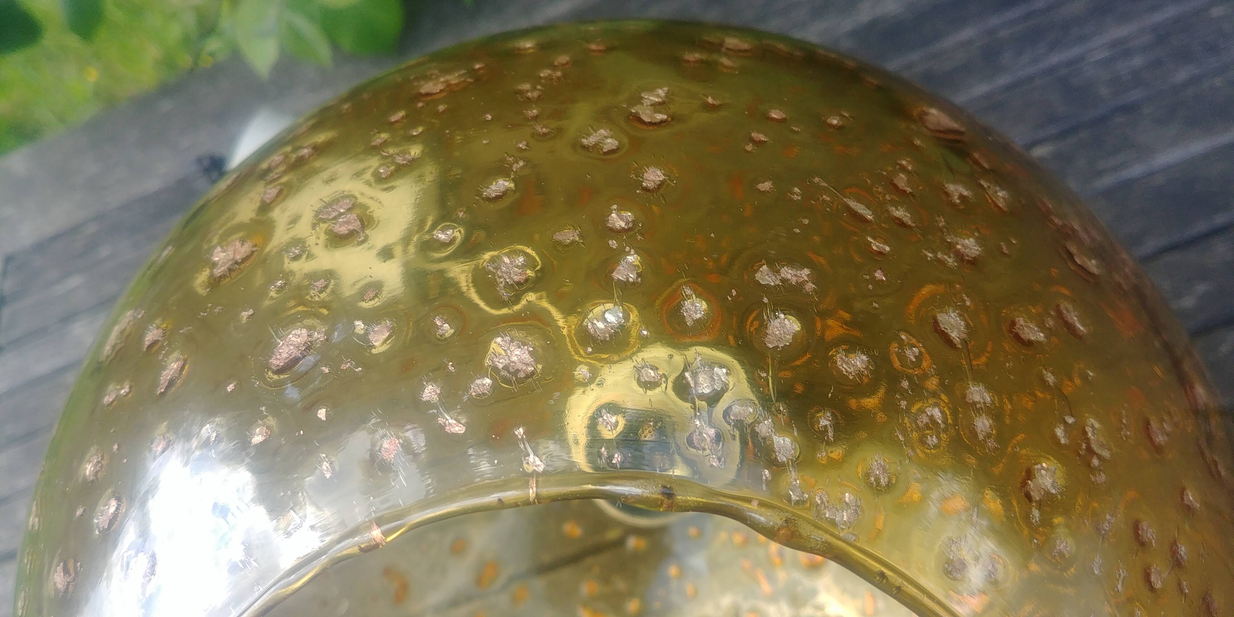 A vintage 70s blown glass pendant light with gold glitter in a globe shape