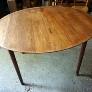 Elegant round teak table with extension.