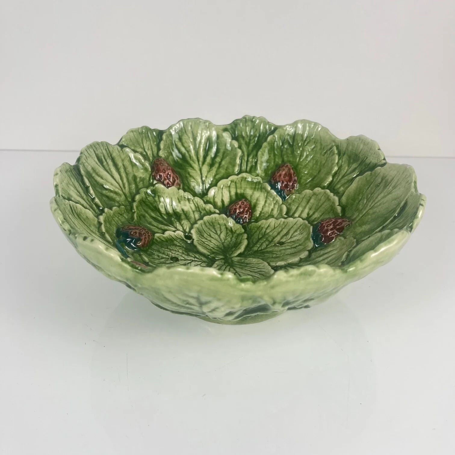 Leaf and strawberry-shaped bowl/strainer.
