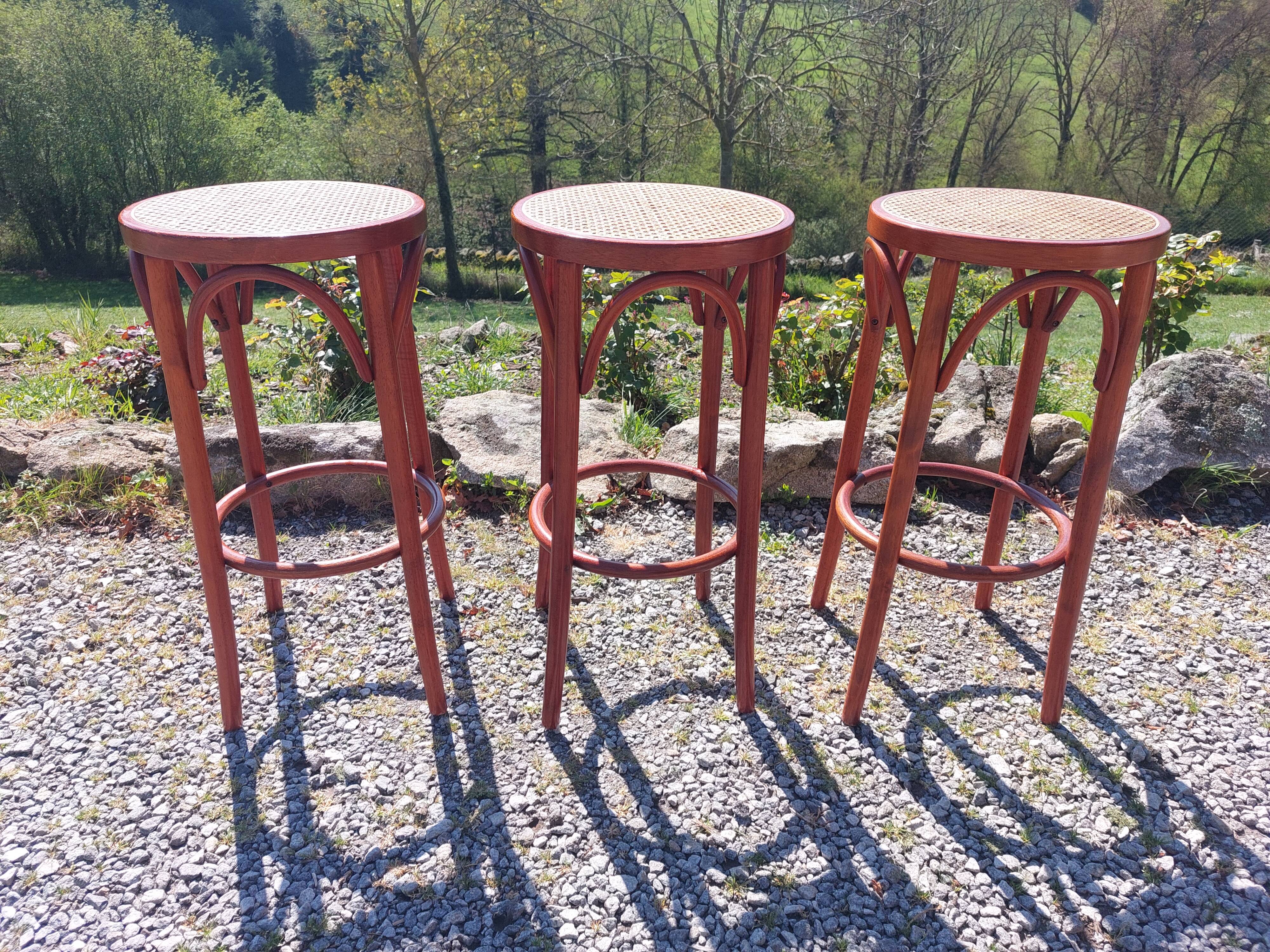 3 wooden and cane bar stools