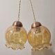 2 iridescent amber luminaires in suspensions