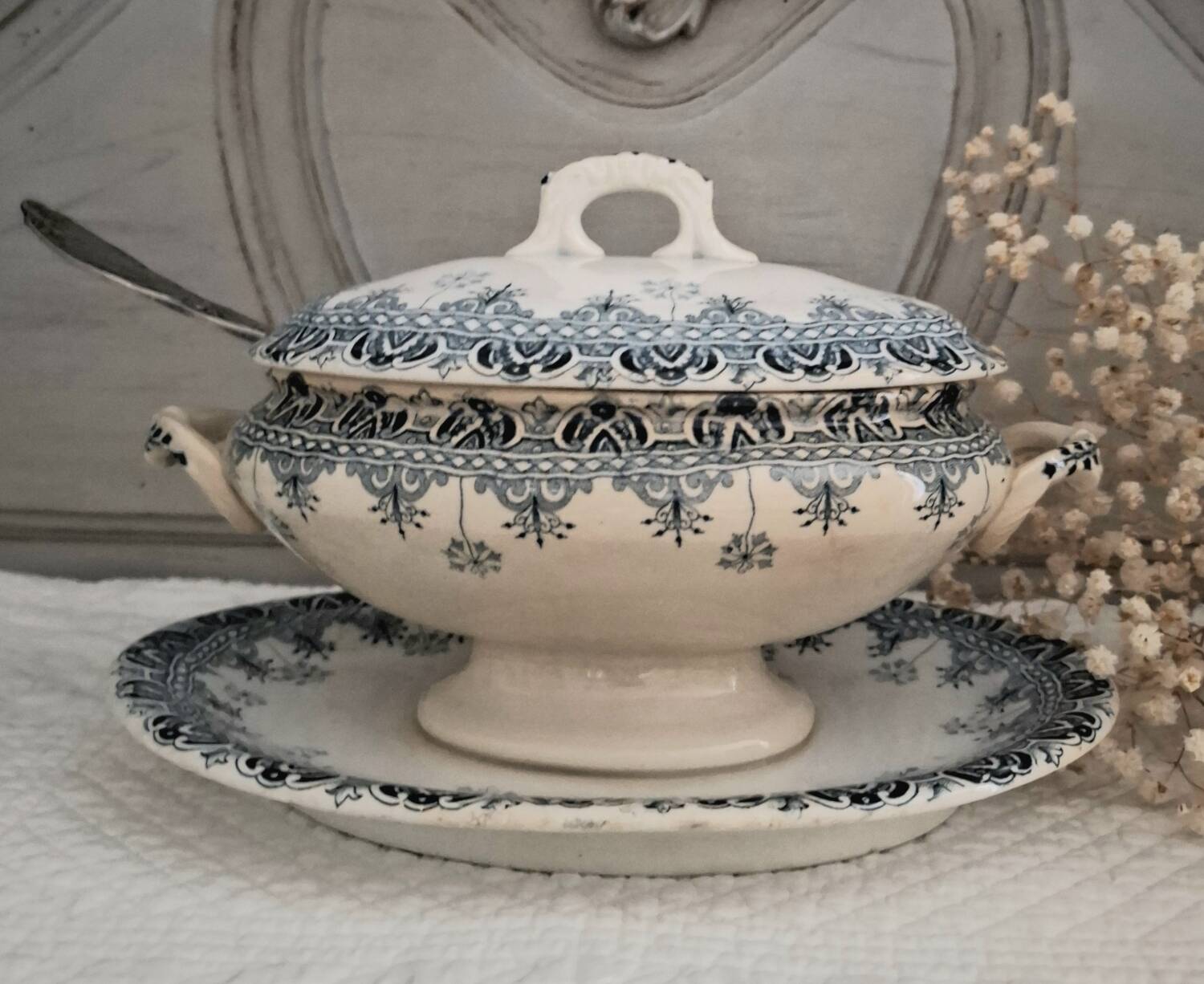 Antique iron earthenware sauceboat on a frame