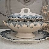 Old iron earthenware sauce boat on frame