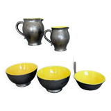 Two pitchers and three Elchinger ceramic bowls black and yellow background 1960