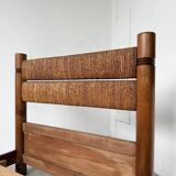 Brutalist style bed with chain and straw
