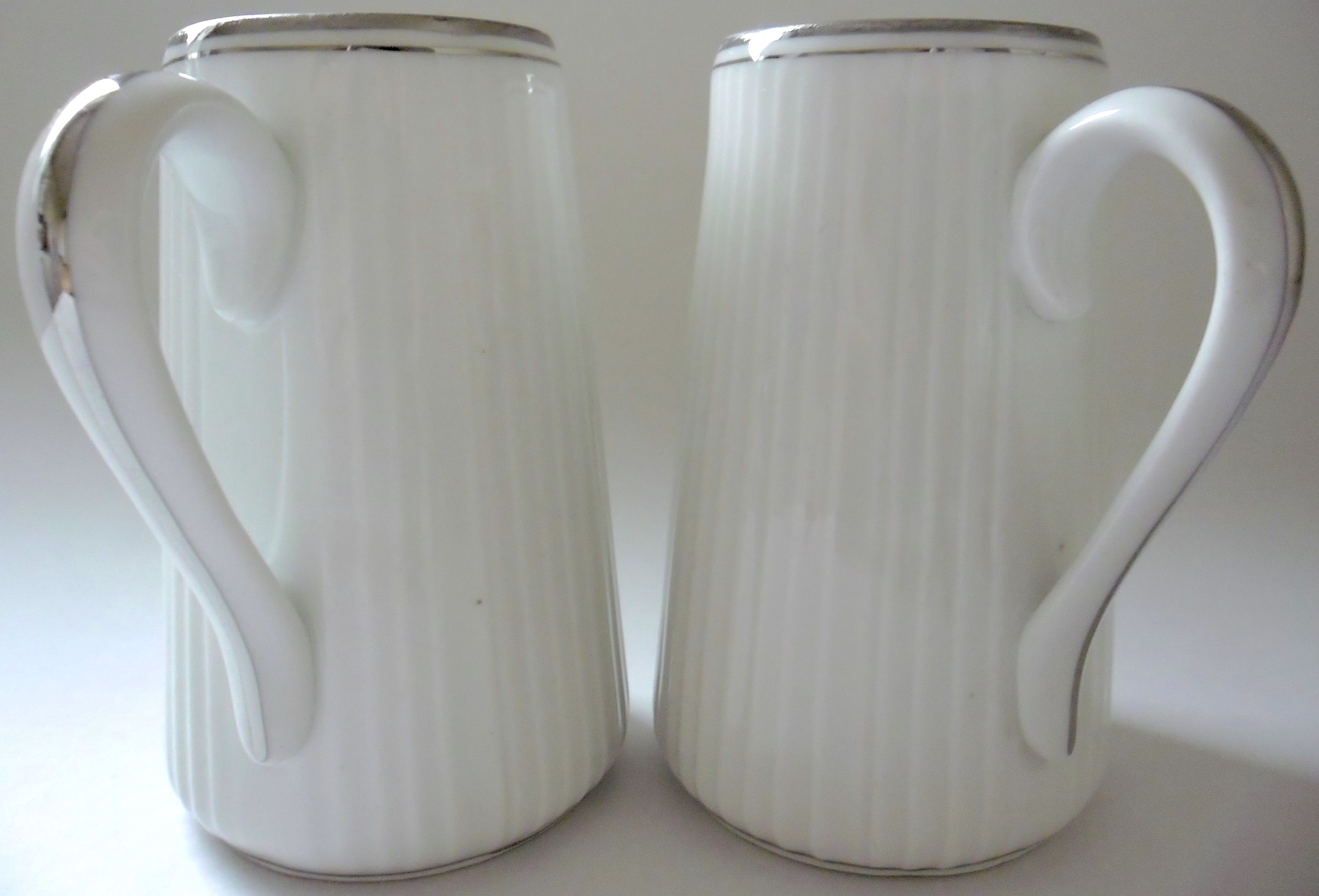 Pair of creamers in white porcelain enhanced with platinum