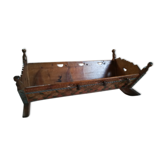 Old rocking painted wooden cradle
