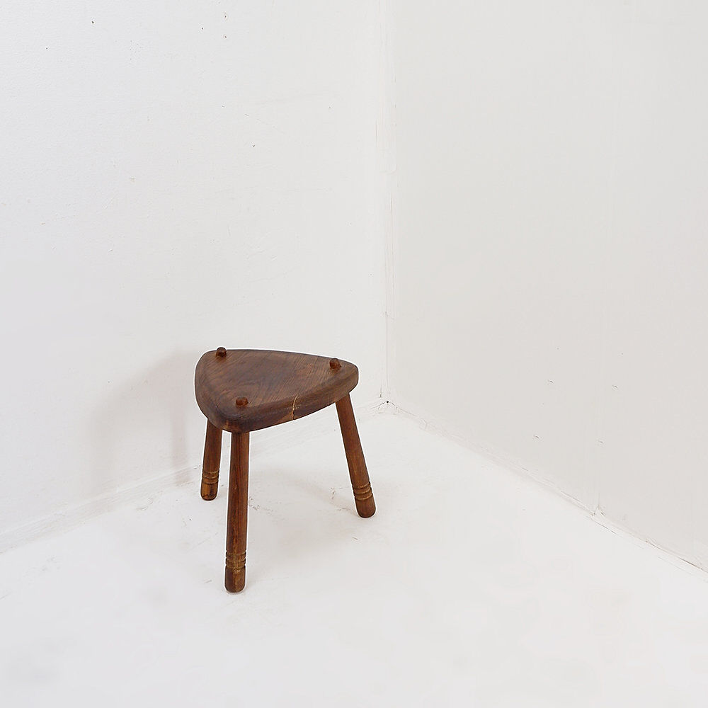 Rustic tripod stool with a triangular seat, 1960s.