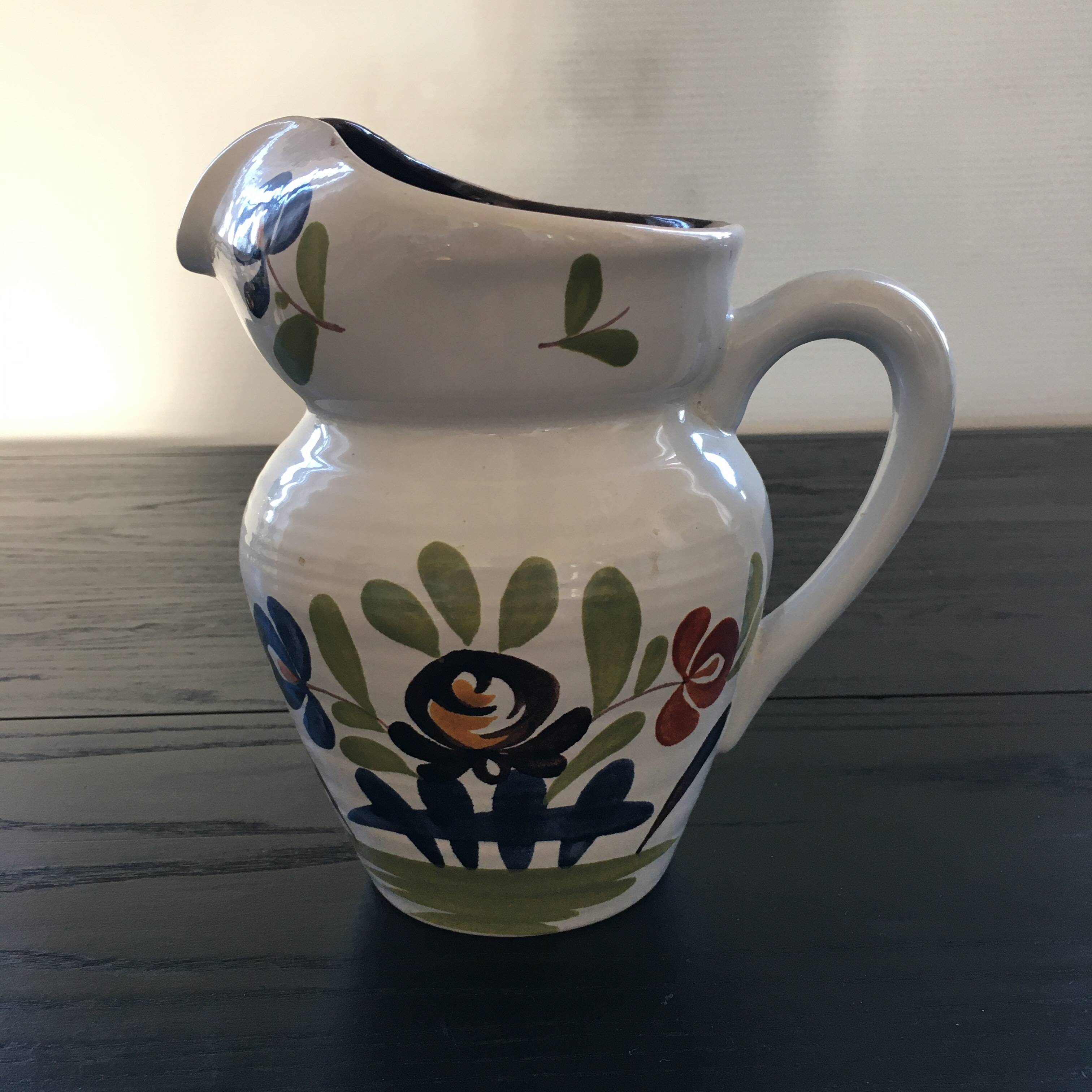 White pitcher with floral decoration