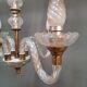 Glass chandelier has 4 lights