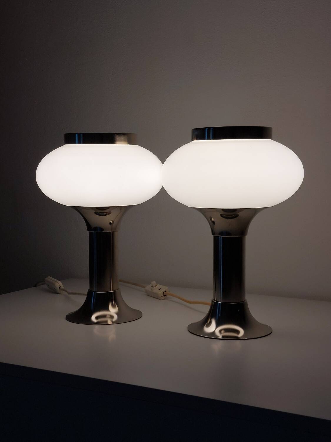 Pair of vintage futuristic style table lamps in chrome and opal glass.