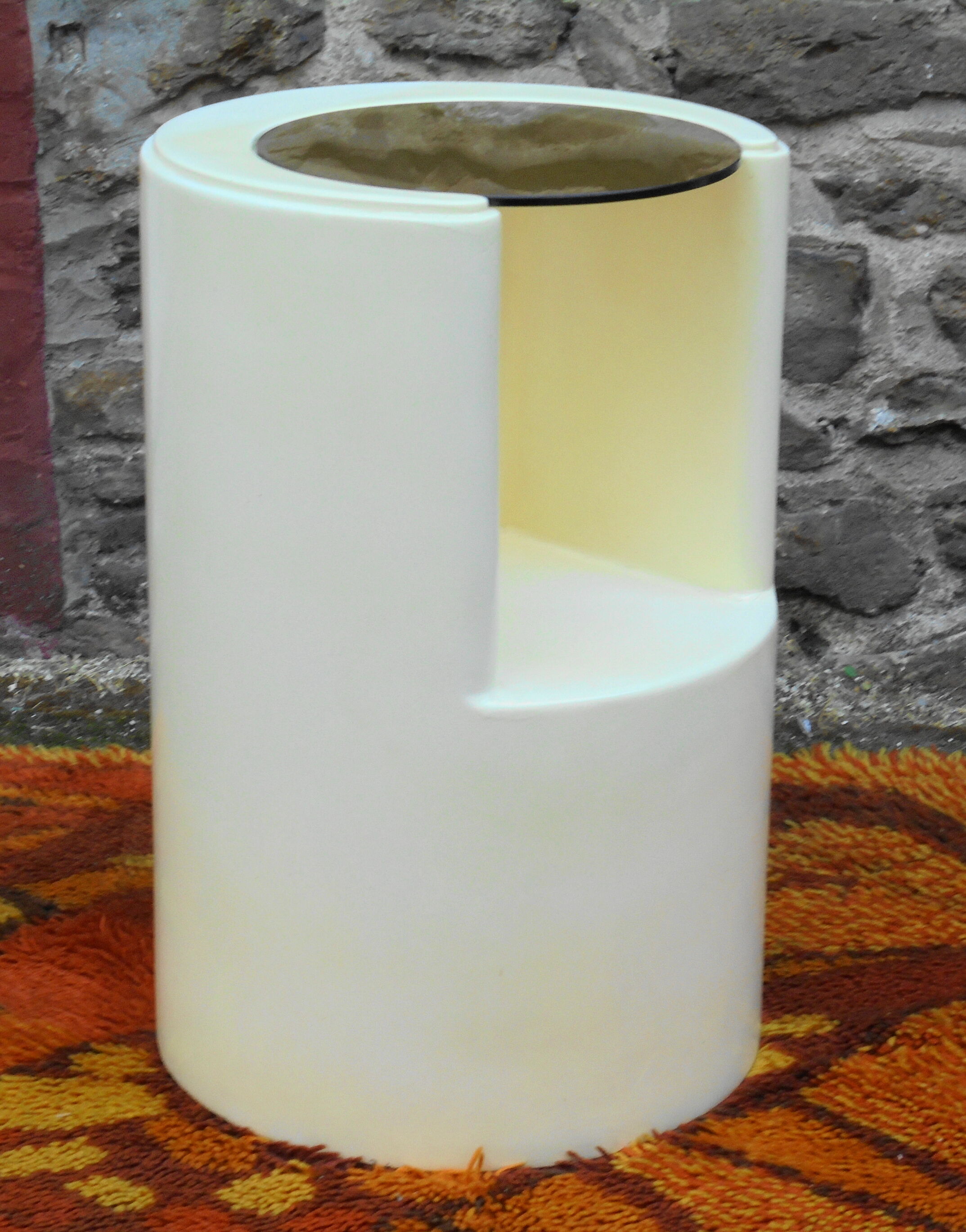 Cylindrical fiberglass bedside table from the 60s