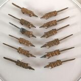 12 vintage bronze knife rests