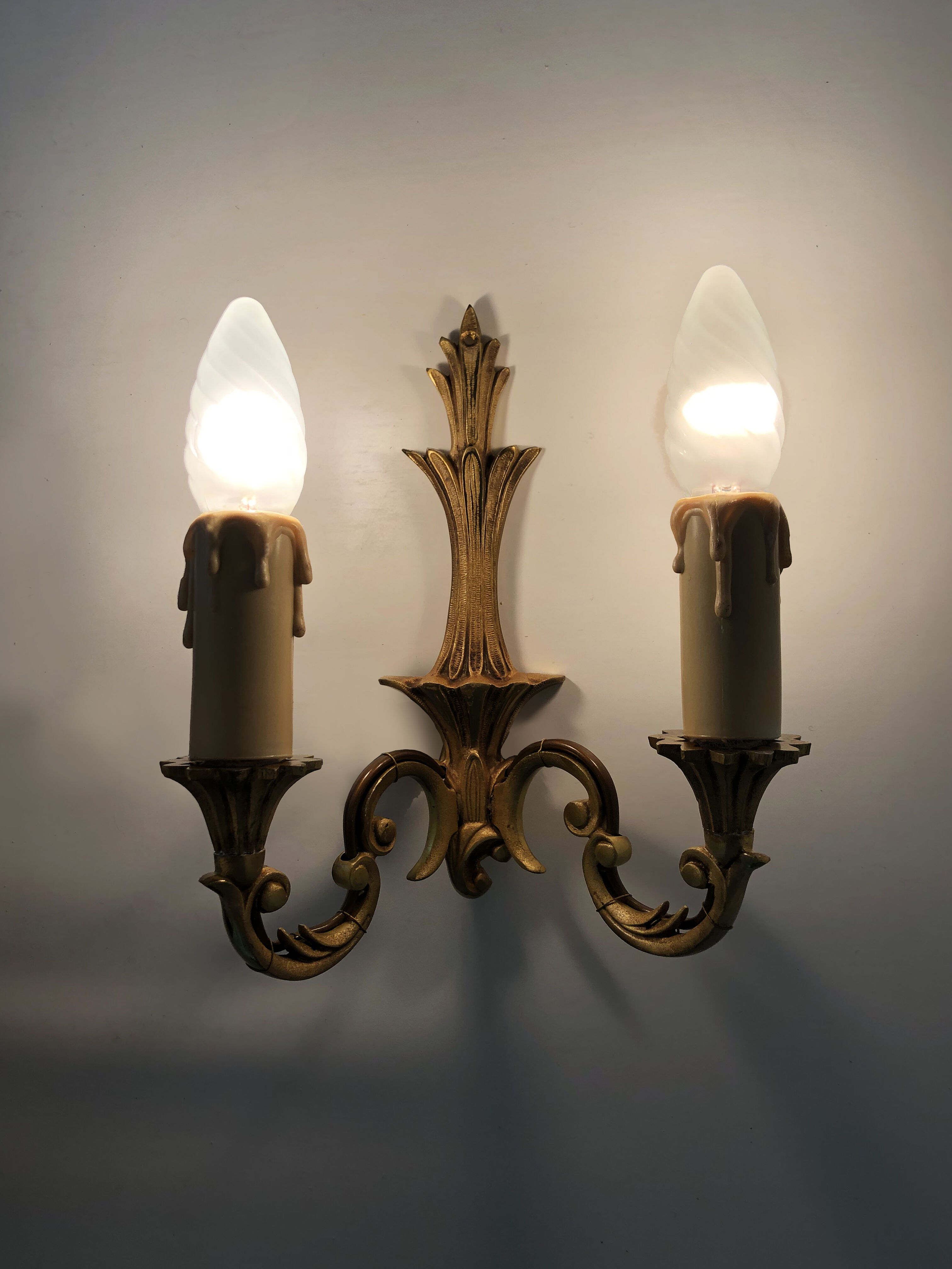 Old pair of wall sconces with double fires in bronze, seventies