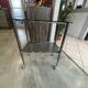 Serving dessert trolley with 2 smoked glass shelves and metal structure.