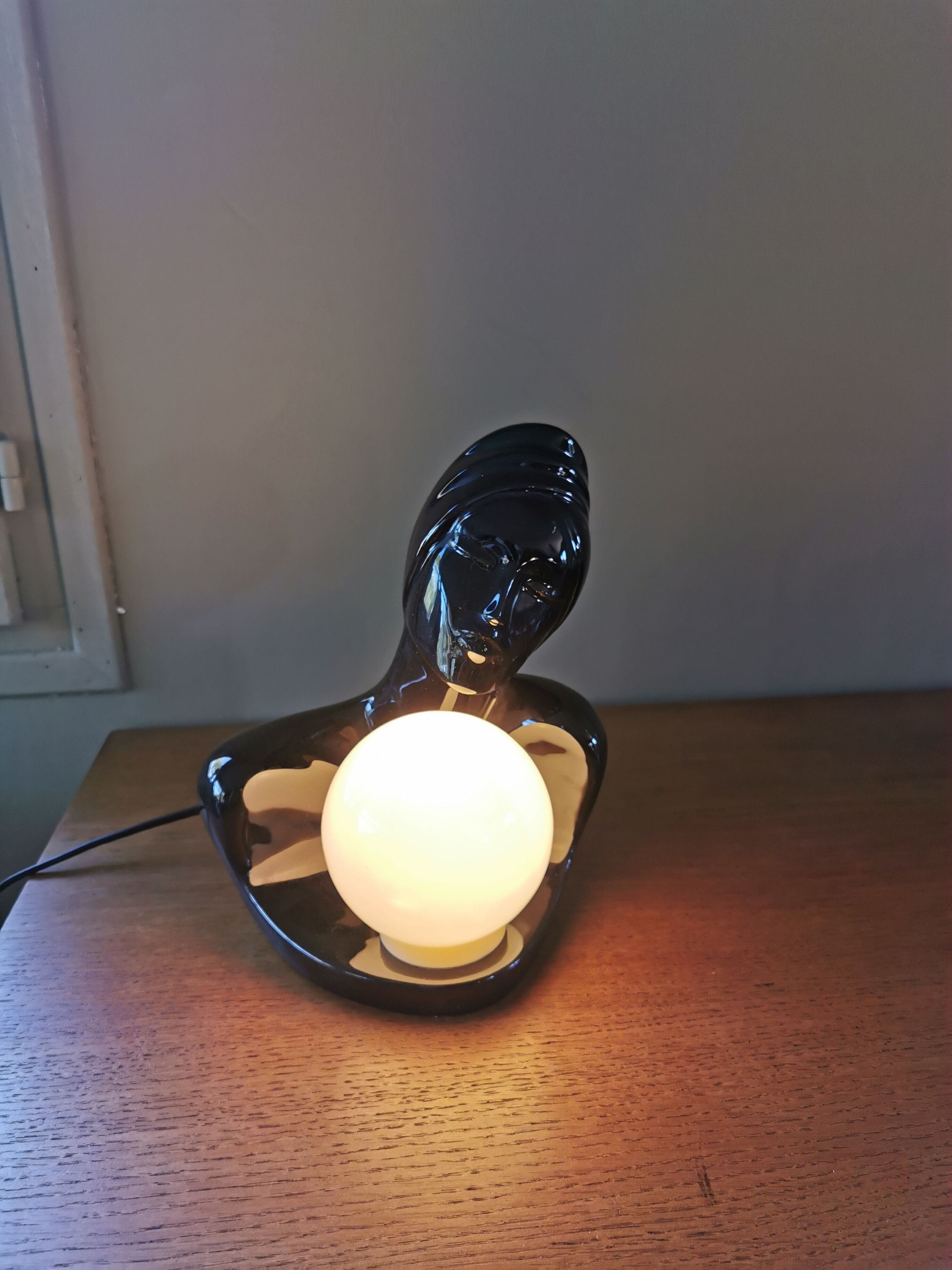 Vintage 80s lamp in the shape of a woman's bust made of black ceramic.