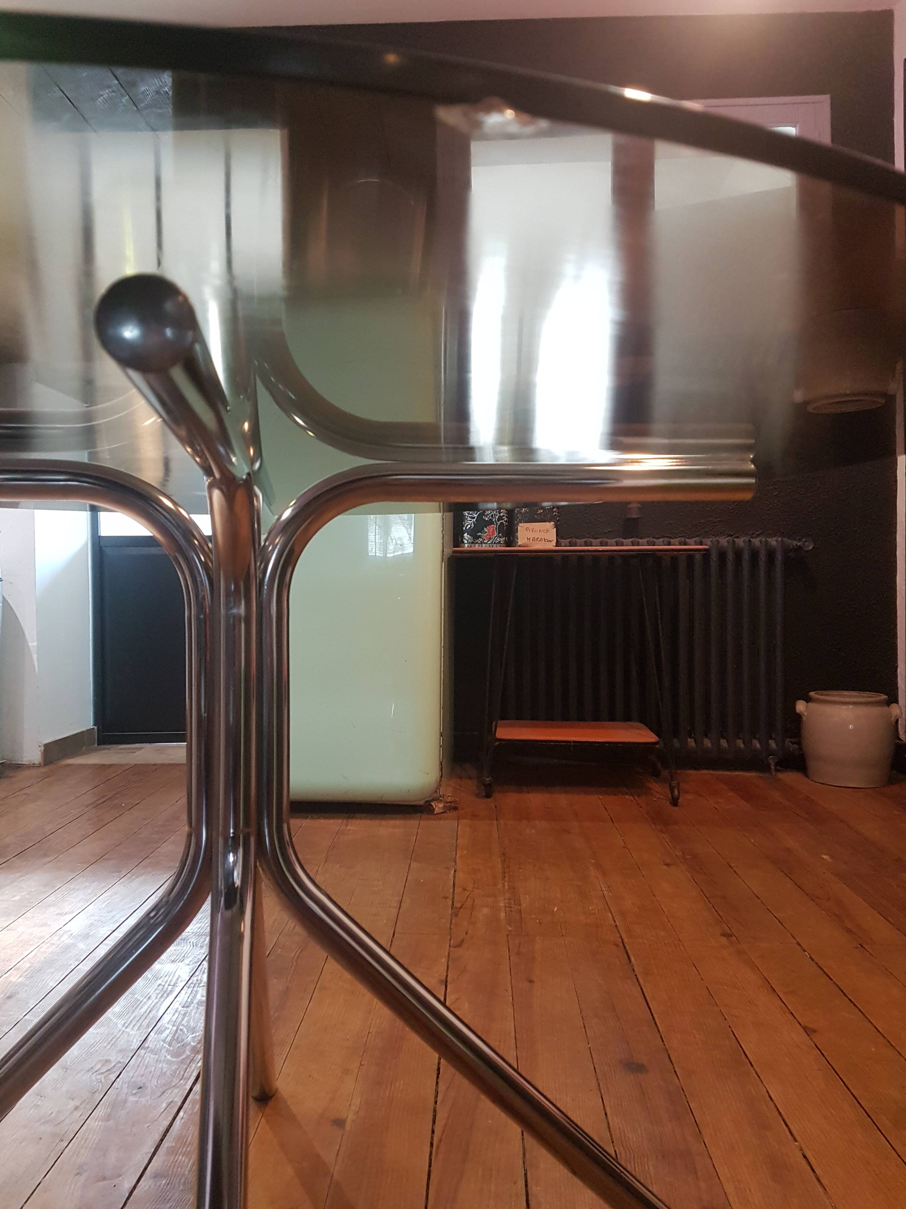 Smoked glass round table and chrome foot