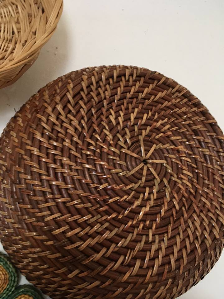 Wall composition of seven baskets and wicker trays.